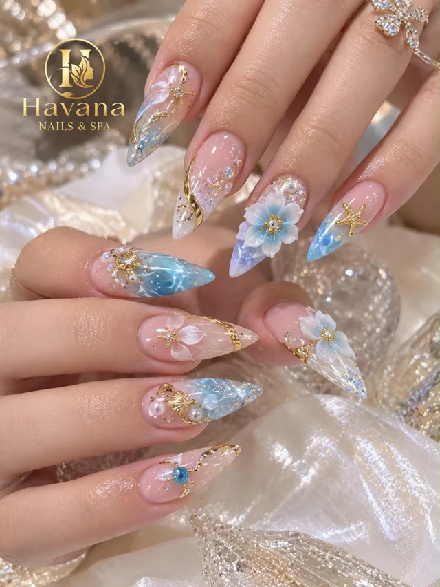 Havana acrylic nails with blue floral art, gold details and crystals